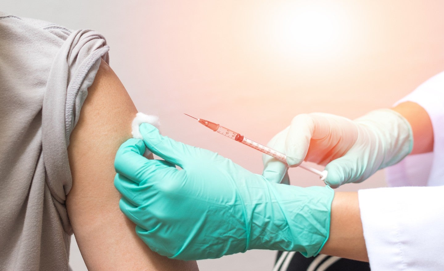 Image of a doctor giving someone a flu shot
